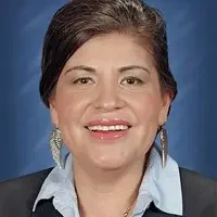 A woman with long hair and wearing a blue shirt.